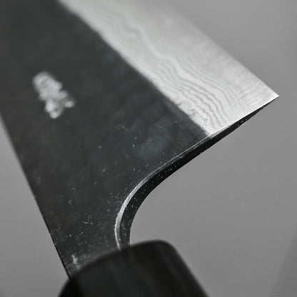 Close-up shot of the choil finish on 240mm Akifusa x Yamamoto tsuchime kurouchi damascus AS gyuto knife