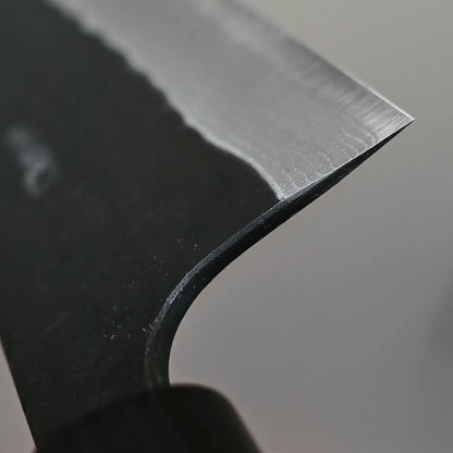 Close-up shot of the choil finish on 210mm Akifusa x Yamamoto tsuchime kurouchi damascus AS kiritsuke gyuto knife