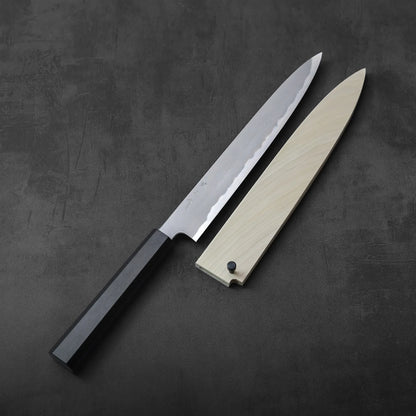 A sujhiki with a black handle and custom magnolia saya, showing contrast between the materials.