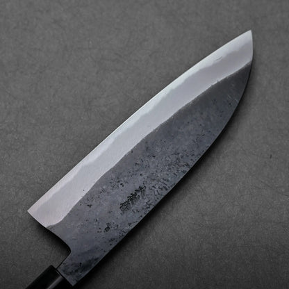 A santoku blade with a dark, textured finish is shown; a Japanese knife featuring a broad, rounded tip.