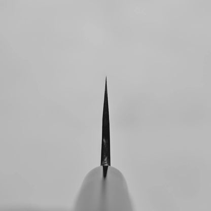 Close-up, black and white image shows the finish and texture of a hand-forged Japanese knife blade by Daisuke Nishida.