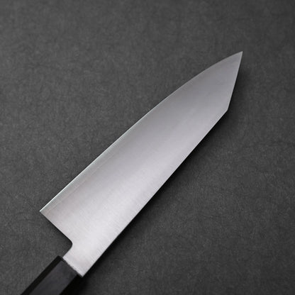 Close-up of the reverse side of a bunka knife made with ginsan stainless steel; photographed to highlight the polished steel finish, pointed tip, and partial view of the dark octagonal handle.