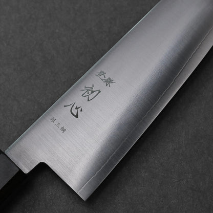 Close-up of a bunka knife made with ginsan stainless steel; photographed to highlight vertically engraved kanji characters and the polished steel finish.