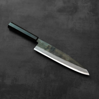 A gyuto with a black handle is shown, highlighting the design and details of the handle and blade.