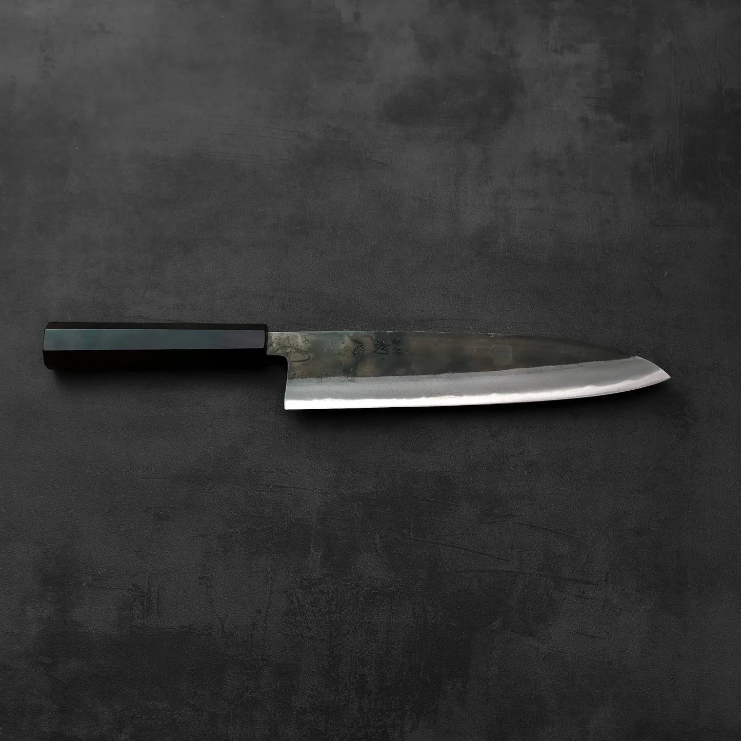 Gyuto with a black handle displayed, highlighting the handle color and blade type.