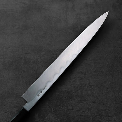 A yanagiba with a black handle is shown, highlighting its classic silhouette and long blade.