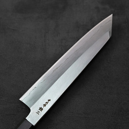 Kiritsuke gyuto knife with a metallic blade and classic handle is displayed prominently.