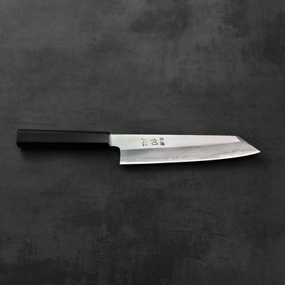 Kiritsuke gyuto with a black handle is shown, highlighting the silhouette and detailing of the blade.