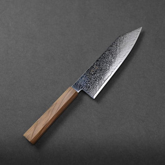 Hatsukokoro Ryuhyo SG2 damascus bunka 180mm knife with a patterned steel blade and a wooden handle rests on a dark gray surface, highlighting its elegant craftsmanship.