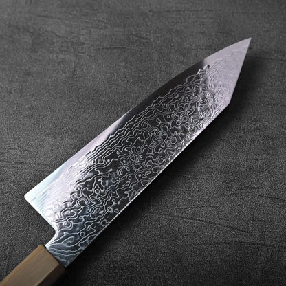 Close-up of a bunka knife with a patterned blade and a visible spine, captured in clear detail.