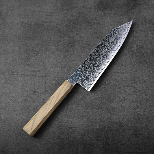Bunka with a light wood handle displayed, showcasing detailed patterns along the blade’s surface.