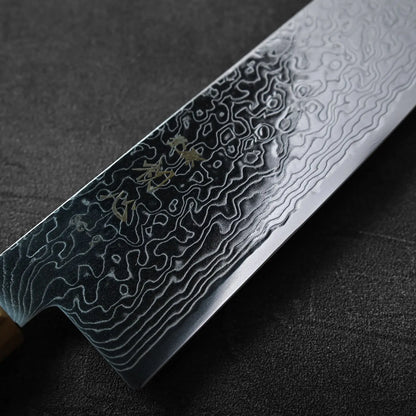 Close-up of a bunka with a damascus 180mm blade and mirror finish, highlighting detailed steel patterns.