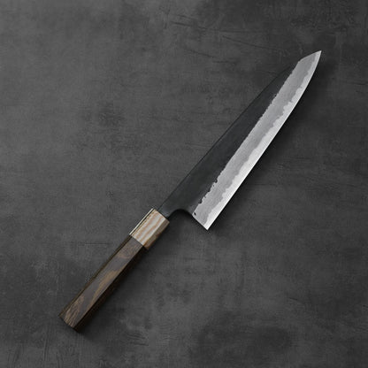 A gyuto with a damascus pattern and kurouchi finish is shown, highlighting its distinctive blade.