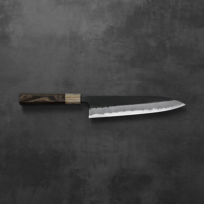 Gyuto with a dark wood handle and damascus pattern along the blade.