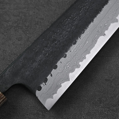 Close-up of gyuto with damascus blade and wooden handle.