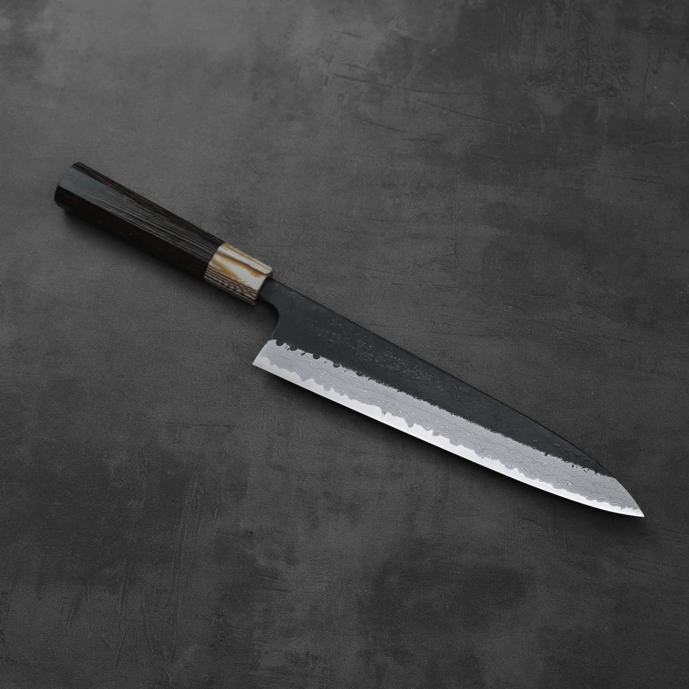 Gyuto with a dark wood handle and a textured gray damascus blade, measuring 240mm.