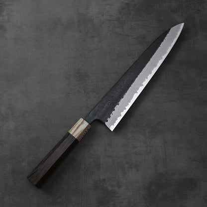 Gyuto chef’s knife featuring a damascus blade with kurouchi finish and a wooden handle.