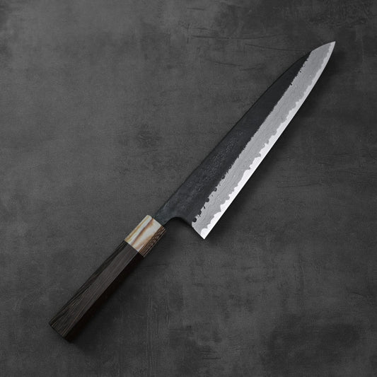 Gyuto chef’s knife featuring a damascus blade with kurouchi finish and a wooden handle.