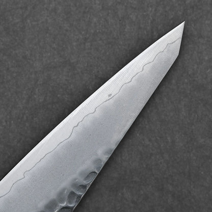 Close-up of the Hatsukokoro tsuchime ginsan honesuki 150mm knife tip, showcasing its hammered tsuchime finish and wavy blade pattern, set against a dark, textured background.