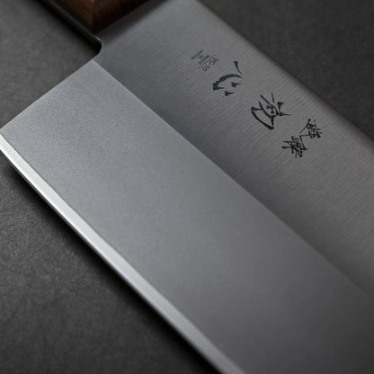 Close-up shows a Japanese knife with a broad, rectangular blade and engraved characters on the VG10 steel surface.