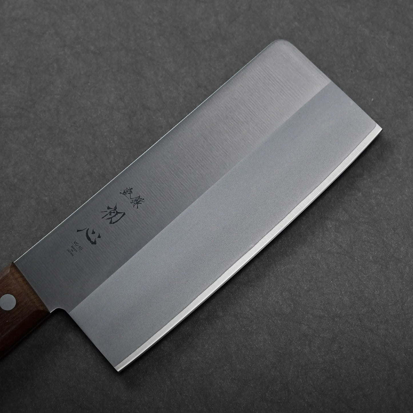 A rectangular-bladed Japanese knife with a straight edge and wooden handle, cleaver style, showing a matte finish.
