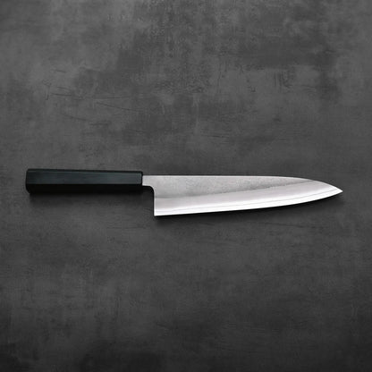 A gyuto with a black handle, 210mm in length, is shown. The stainless blade features a nashiji finish.