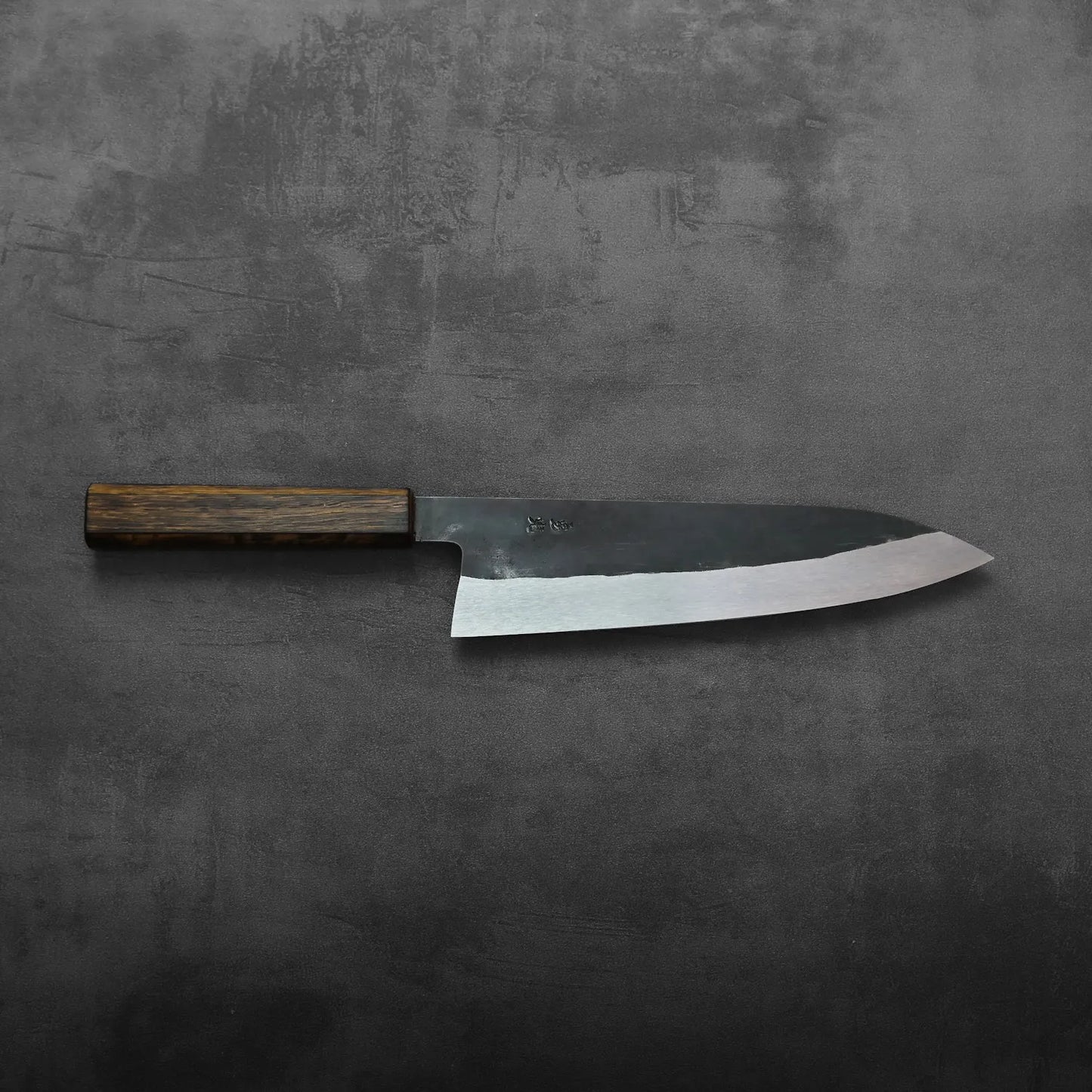A gyuto with a wooden handle, featuring a tall blade, is displayed without background elements visible.