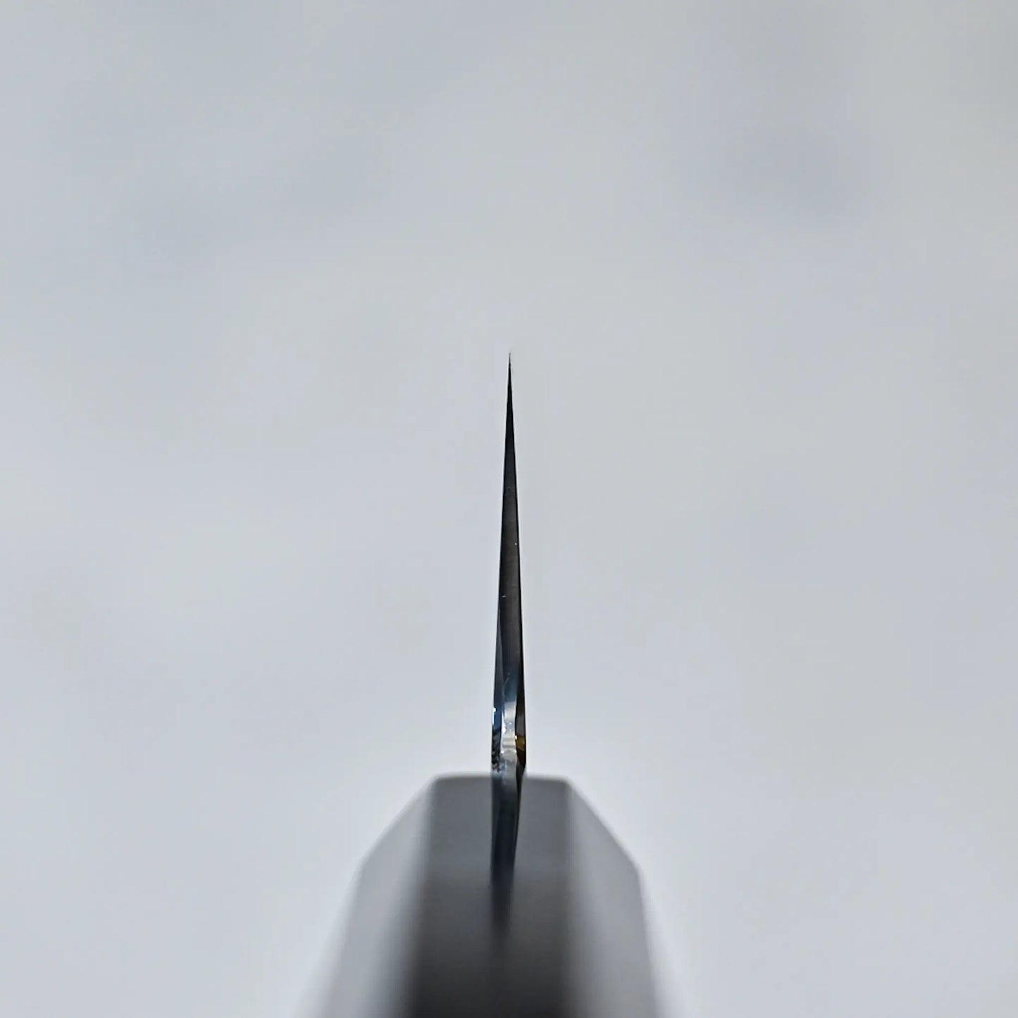 Choil shot of a Mizuhonyaki gyuto blade tip showing its cross-sectional geometry, part of a Japanese knife.