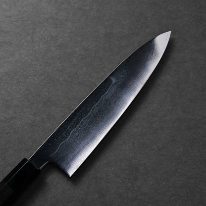 The Japanese knife shown is a Mizuhonyaki gyuto with a visible curved edge and pointed tip, featuring a dark handle.