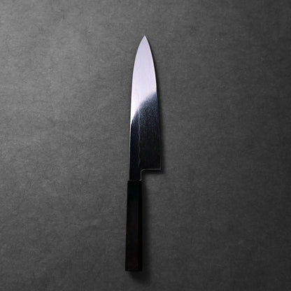 The image shows a Japanese knife, a Mizuhonyaki gyuto with a black handle and a straight-edged blade with subtle patterning.