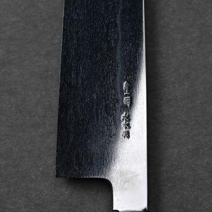 Detailed view of metal texture and kanji characters on a Japanese knife, Mizuhonyaki gyuto blade shape not fully visible.