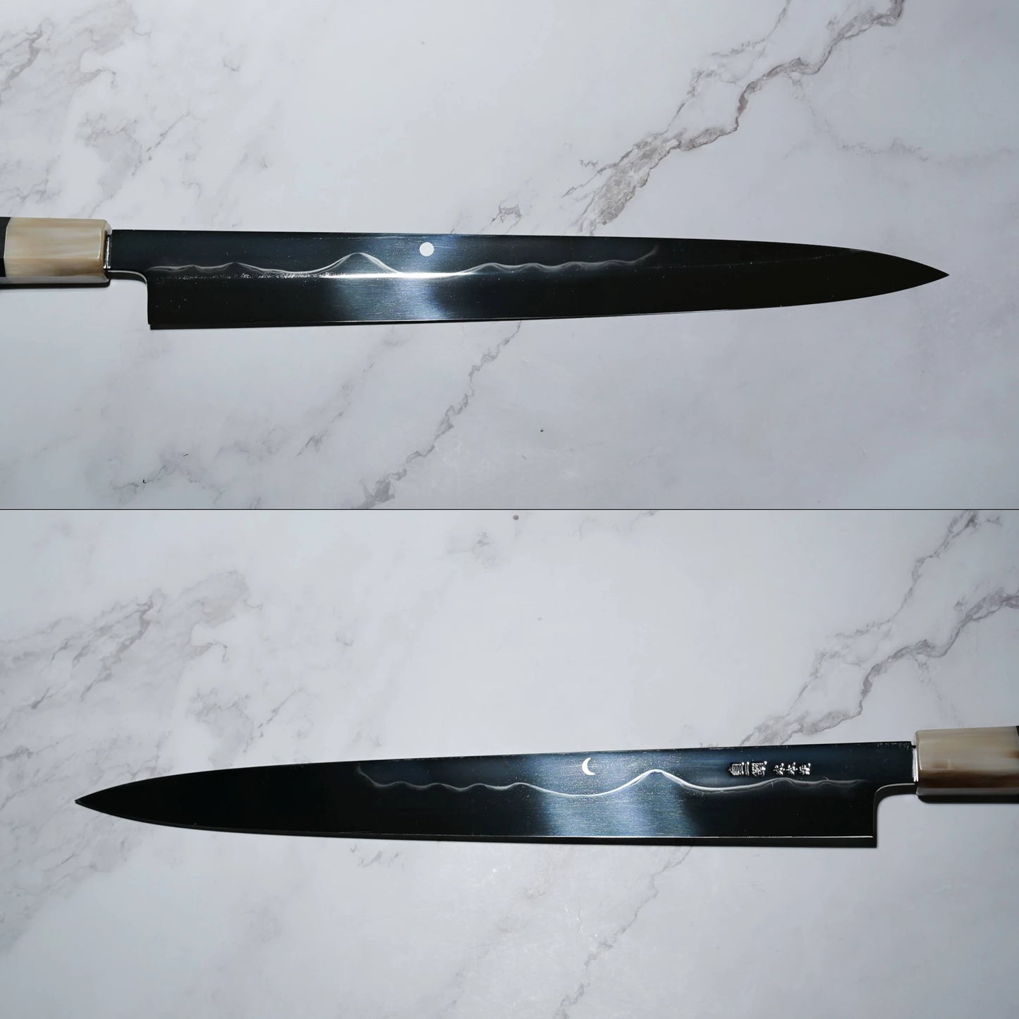 Two views of a Japanese honyaki yanagiba knife placed on a marble-patterned surface. The long, single-bevel blade has a pointed tip and features a decorative hamon resembling Mt. Fuji, indicating differential hardening. The top view shows a circular moon mark near the spine; the bottom view reveals a crescent moon motif and engraved kanji near the handle.