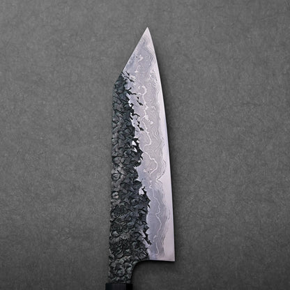 The blade has a kiritsuke gyuto shape with visible Damascus patterning; a Japanese knife shown in the image.