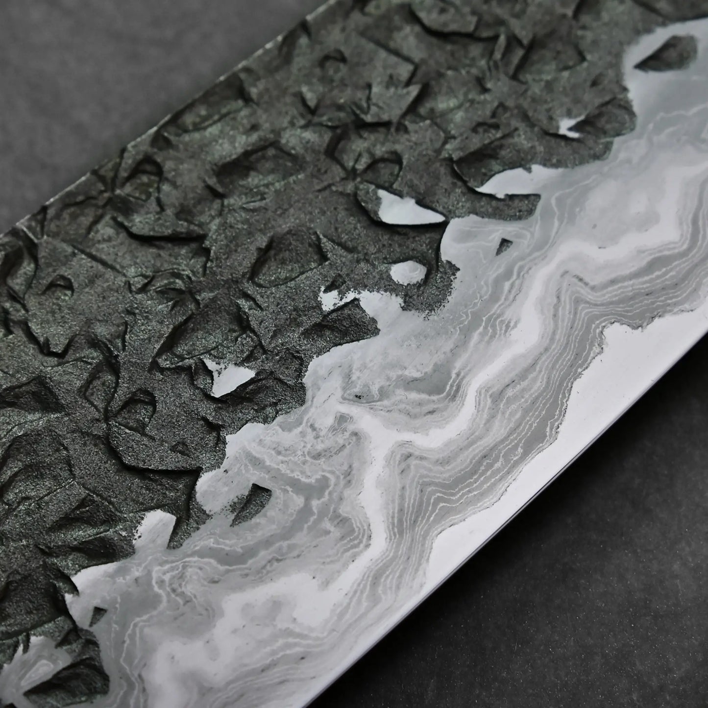 Close-up shows a Japanese knife blade with visible Damascus steel patterns and a distinct wavy polished edge.