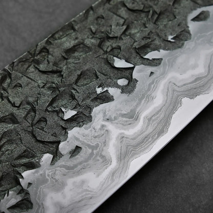Close-up shows a Japanese knife blade with visible Damascus steel patterns and a distinct wavy polished edge.