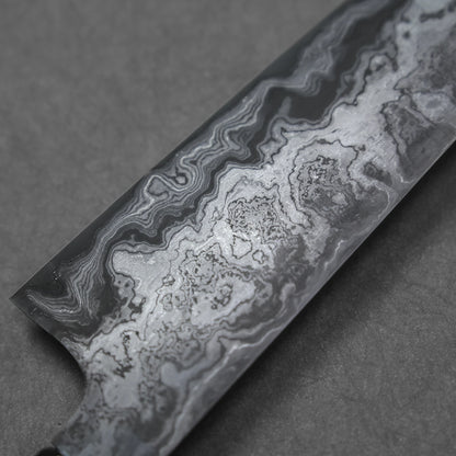 Close-up of a Damascus steel knife blade with intricate, wavy forge patterns indicating layered steel construction.