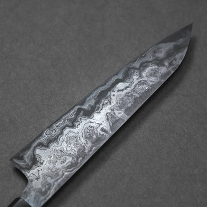 Close-up of a Damascus steel knife blade showcasing fine wavy forge patterns and subtle, layered texture.
