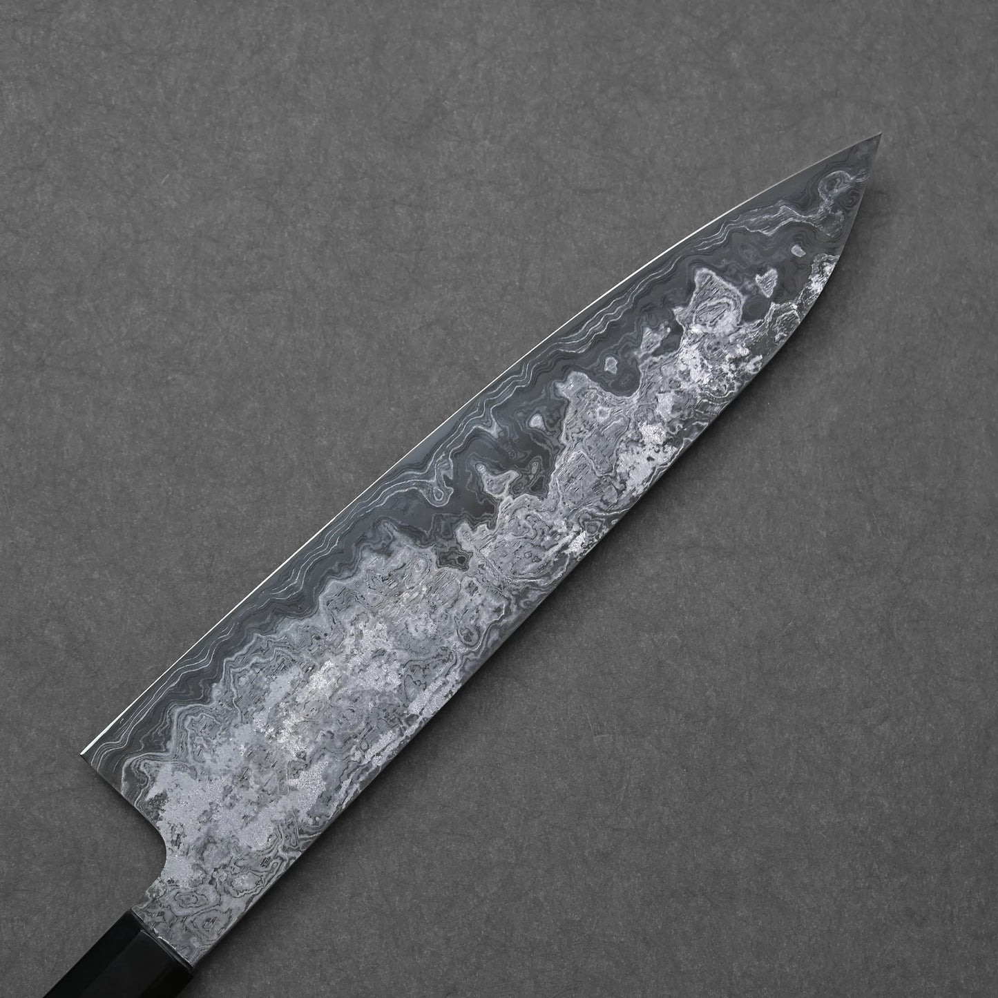 Decorative knife with a unique blade pattern on a gray background