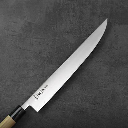 A sujihiki with a saya is shown. The blade and wooden sheath are placed side by side for display.