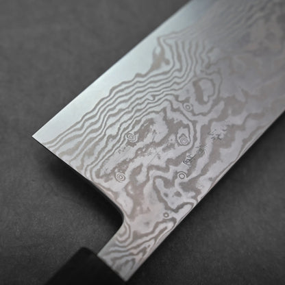 Close-up of a Miyazaki ATS34 bunka knife blade with visible Damascus steel patterning, featuring intricate, wavy lines and swirls on the metal surface against a dark background.