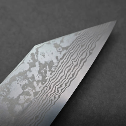 Close-up of a Miyazaki ATS34 bunka knife blade with visible Damascus steel patterns, showing wavy lines and circular marks on a gray, matte background.