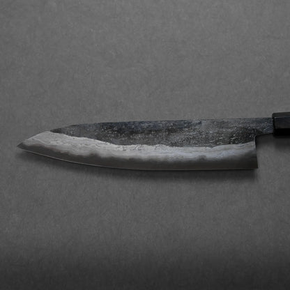 A close-up of a Japanese-style kitchen knife with a dark handle and a polished, patterned blade, highlighting its elegant craftsmanship against a gray background.