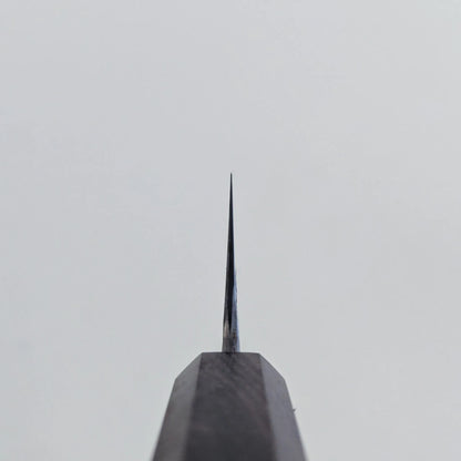 Choil shot of a Miyazaki rentetsu gyuto blade against a plain, light gray background. The image emphasizes the thinness and craftsmanship of the blade’s tip.