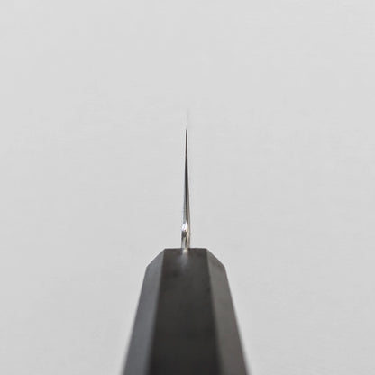 Choil shot of a santoku knife; photographed to emphasize the grind transition