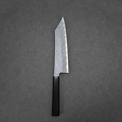 The Nigara tsuchime damascus VG10 kiritsuke gyuto 210mm, featuring a dark wooden handle, is displayed on a plain gray surface.