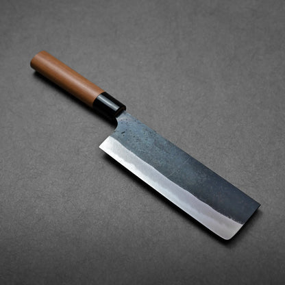 Rectangular blade with straight edge and a wooden handle, this Japanese knife appears to be a nakiri.