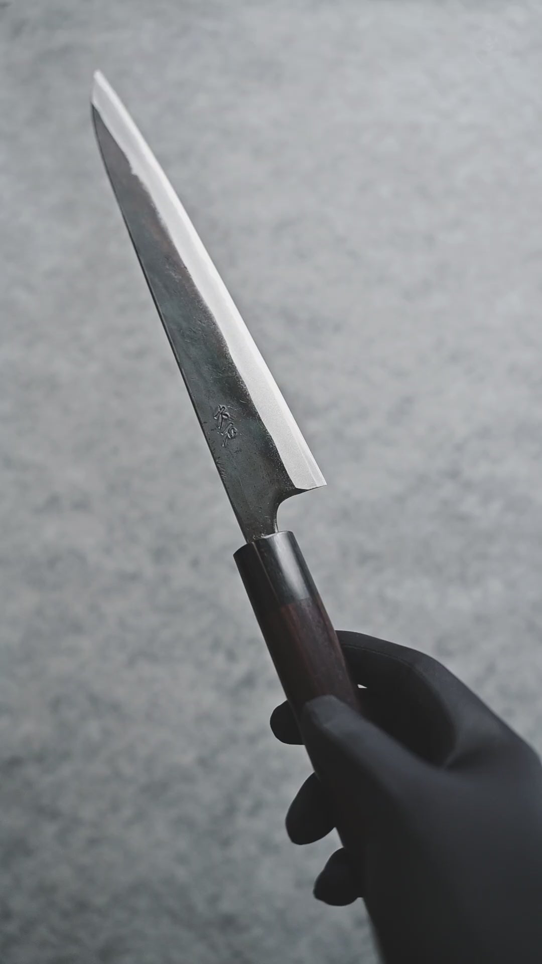 Video displaying Ohishi Kurouchi Aogami #1 Sujihiki 240mm against gray background. Shows multiple angles of this high-carbon Japanese chef's knife