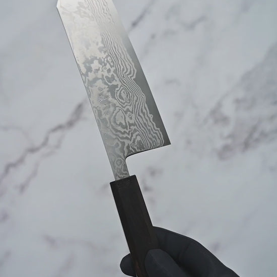 Short video showcasing a damascus ATS34 bunka knife from Miyazaki, rotating to display the blade, handle, and overall craftsmanship from multiple angles.