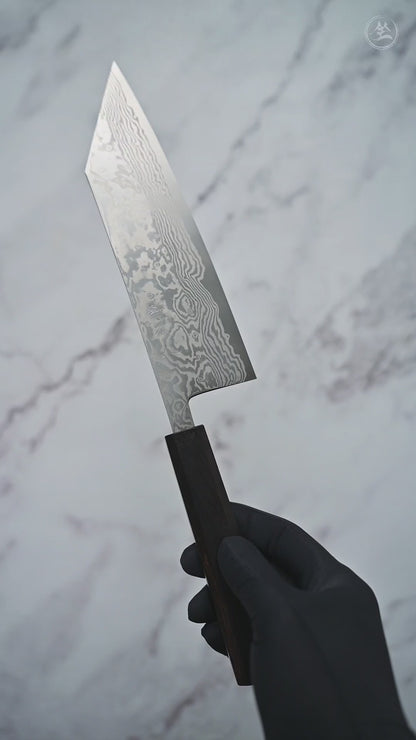 Short video showcasing a damascus ATS34 bunka knife from Miyazaki, rotating to display the blade, handle, and overall craftsmanship from multiple angles.