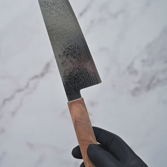 Short video showcasing a damascus SG2 bunka knife from Hatsukokoro, rotating to display the blade, handle, and overall craftsmanship from multiple angles.